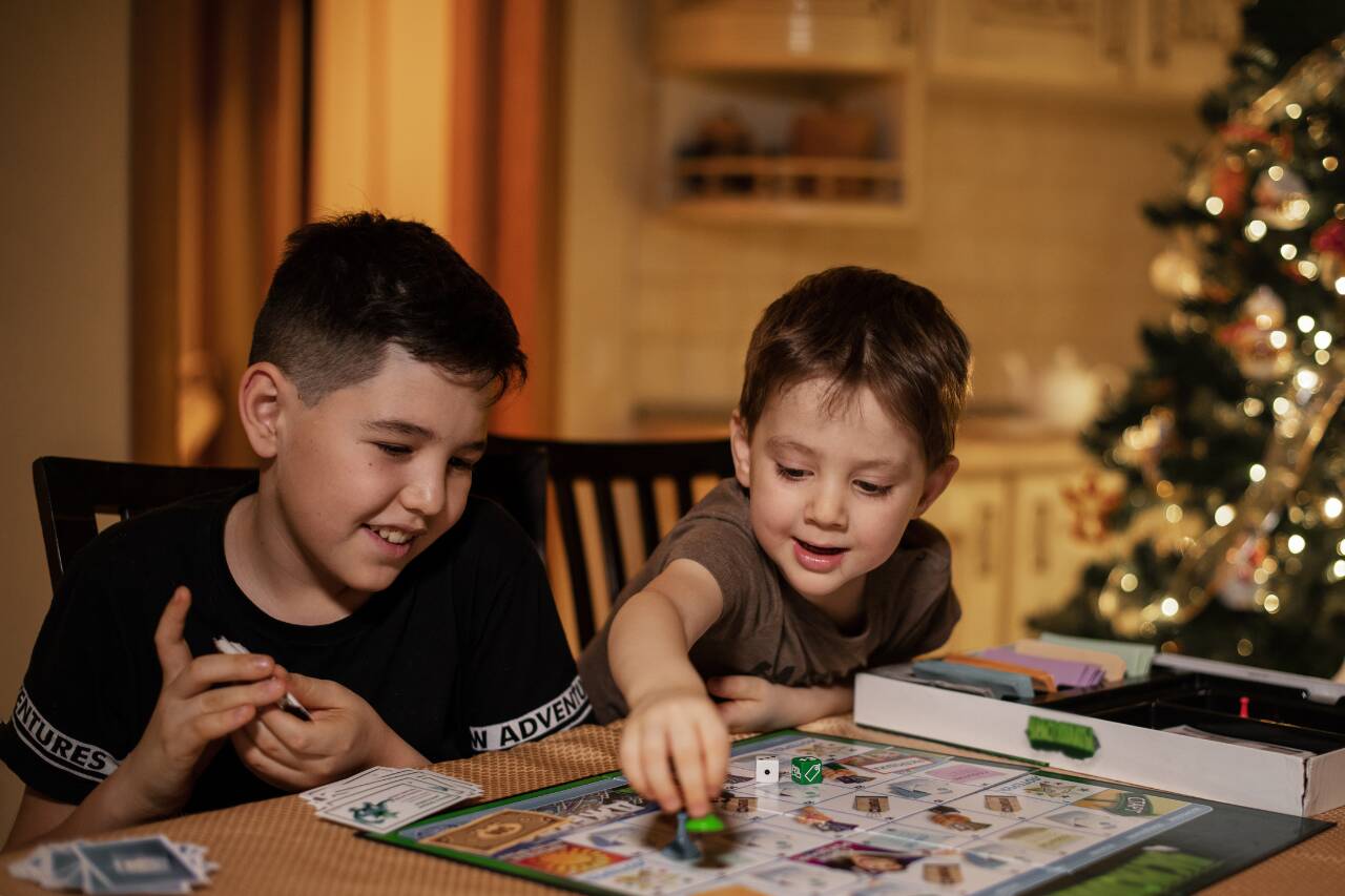 Crianças jogando jogo de tabuleiro durante o Natal